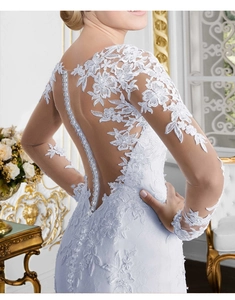 Détail du dos d'une robe de mariée en dentelle blanche avec boutons en perles élégants