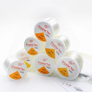 Pyramid stack of clear elastic beading cord rolls for DIY jewelry making 100M length