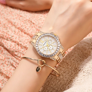 Detail of starry crystal gold watch with three sub-dials and matching initial A bracelet