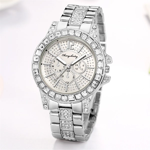 Close-up view of elegant women's watch with rhinestone bezel and silver steel band.