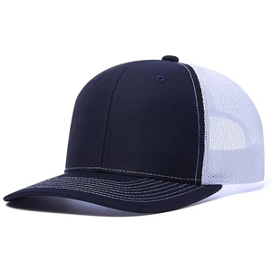 Detail of navy and white mesh trucker hat showing breathable back and contrast stitching