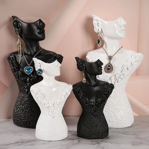 Elegant mannequin bust jewelry displays in black and white for necklaces and earrings