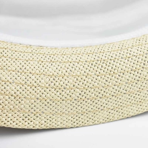 Macro detail of natural straw weave and white fabric lining on a linen sun hat