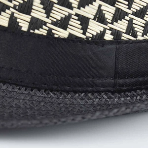 Detailed macro shot of the black and white geometric woven pattern and satin hat ribbon