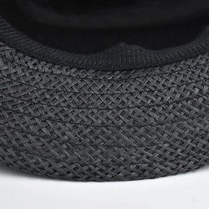 Close-up of the woven texture and black inner sweatband on a linen fedora hat