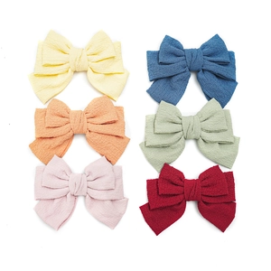 Set of six colorful pleated fabric bow hair clips in yellow blue pink and red colors