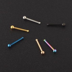 Macro view of straight stud nose rings in silver, gold, black, and multi-color finishes