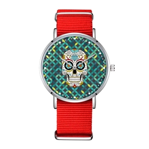 Fashionable green skull quartz watch with a vibrant red nylon strap and silver case on white