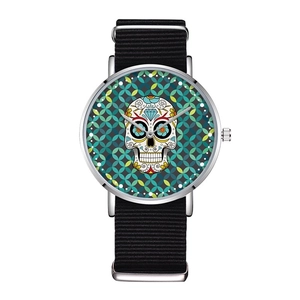 Detail showing fashion watch with sugar skull dial and black nylon NATO strap