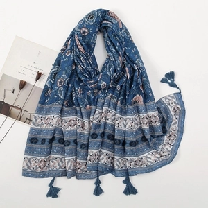 Vintage bohemian blue floral scarf with elegant tassels on a minimalist background