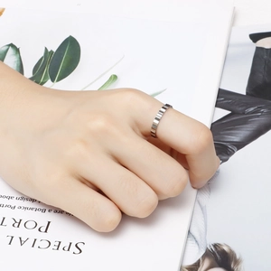 Minimalist silver steel ring featuring unique tiered geometric texture on model hand