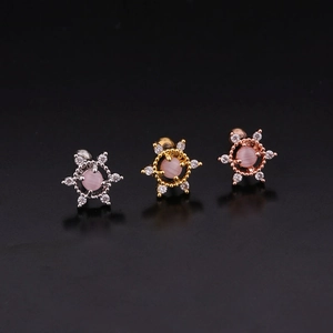 Detailed view of snowflake earrings in silver, gold, and rose gold with pink cat eye stones
