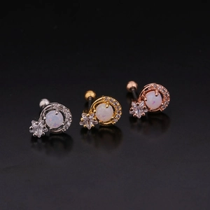 Detailed view of moon and star earrings in silver, gold, and rose gold finishes