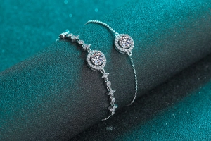 Detail of S925 silver moissanite bracelets on a luxury dark green textured display