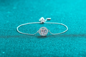 Macro shot of S925 sterling silver bracelet showing moissanite main stone and halo details