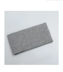 Detailed macro view of the grey ribbed knitted headband texture and soft cotton fabric