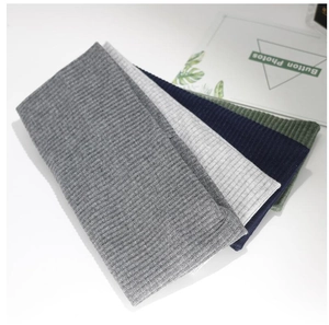 Detail of ribbed knit headbands in dark grey, light grey, navy, and olive green colors