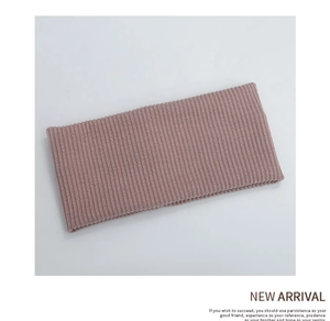 Detail of rib-knit texture on a dusty pink elastic headband for sports and daily wear