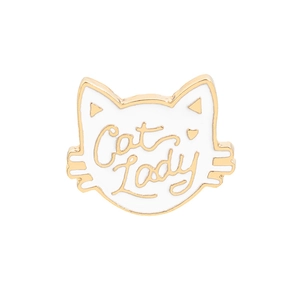 Detail of white enamel cat head brooch with gold Cat Lady text engraving