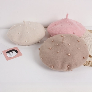 Detail of wool blend pearl berets for girls in pink, beige and light brown colors
