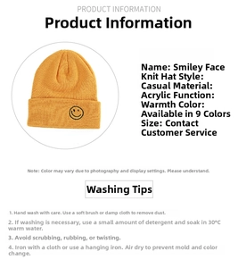 Detail view of bright yellow knitted beanie featuring smiley face embroidery patch