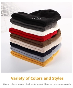 Close-up of colorful winter beanies with detailed smile embroidery and thick knit texture