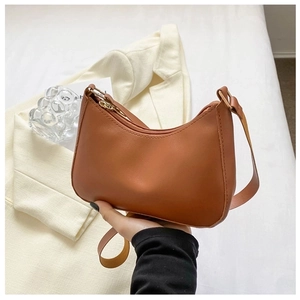 Detail of a brown half-moon underarm bag made of smooth PU leather with top zipper