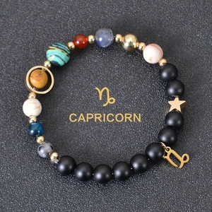 Detail of Capricorn beaded bracelet with matte black stones and colorful planet beads