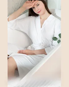 Detail of white waffle weave bathrobe fabric texture with minimalist tie-waist design
