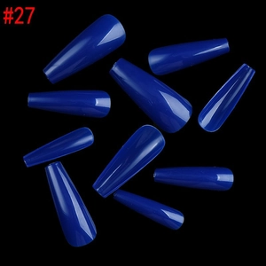 Close-up of glossy royal blue coffin nails with smooth finish on a dark background