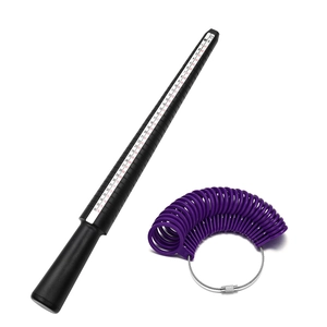 Macro view of purple sizing rings and black mandrel tool for US and UK sizes