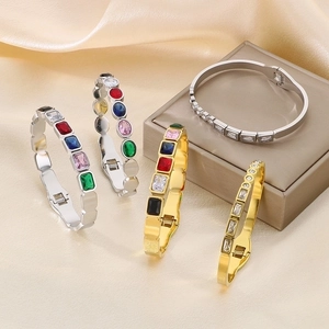 Detailed close-up of colorful zircon inlay and stainless steel texture on a jewelry box