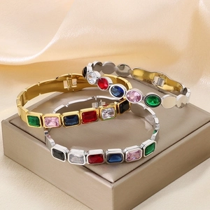 Gold and silver stainless steel bracelets with colorful zircon stones on silk fabric