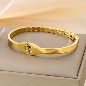 Golden stainless steel bracelet with zircon stones and spring clasp on jewelry box