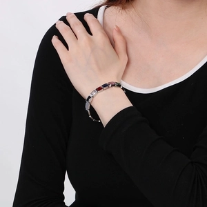 Detail view of a silver stainless steel bracelet with multi-color rectangular gemstones