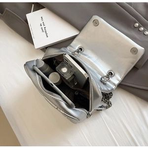 Interior view of silver quilted chain bag showing capacity for phone and cosmetics