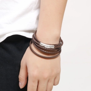 Men's vintage brown multi-layer braided leather bracelet with silver metal clasp on wrist