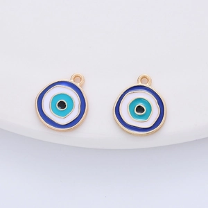 Detail of evil eye charms with blue and white enamel inlay and golden finish