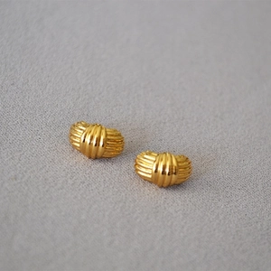 Elegant gold brass stud earrings with vertical striped texture and retro fashion style