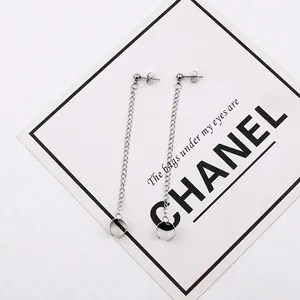 Detailed view of silver stainless steel chain earrings with stud and ear cuff attachment