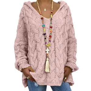 Detail of pink chunky cable knit texture on a loose hooded sweater for autumn winter