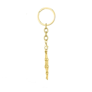 Detailed close-up of golden metal key chain featuring link chain and lobster clasp