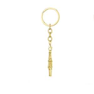 Detailed view of a shiny golden metal keychain with lobster clasp and elegant fringe tassel