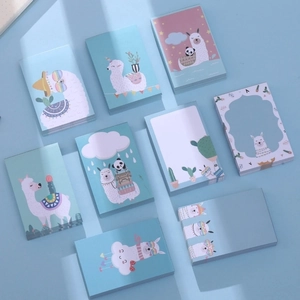 Flat lay of multiple cute cartoon alpaca pocket notepads with pastel blue and pink covers