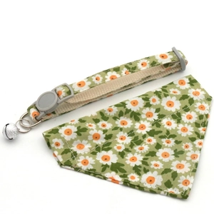Close-up of green daisy pattern pet bandana and adjustable collar with silver bell