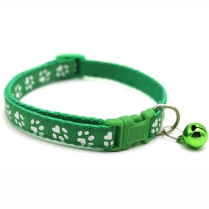 Green pet collar with white paw prints featuring a matching metal bell and plastic buckle