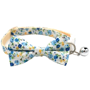 Detailed view of blue floral pet collar with cotton bowknot and metal safety bell