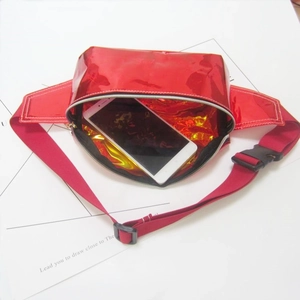 Internal capacity view of red shiny fanny pack with a smartphone inside showing size