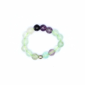 Detail of 4mm natural fluorite beaded elastic ring with green and purple crystal textures