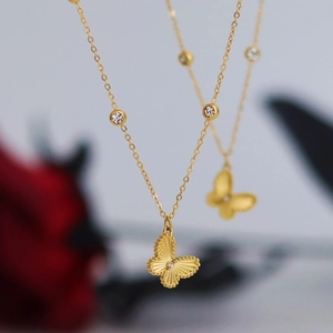 Golden butterfly necklace with laser phantom wings and zircon accents on a fine chain